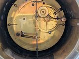 a metal container with a clock inside of it