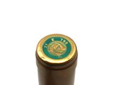a close up of a bottle of wine on a white surface