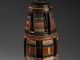 an image of a wooden vase with many books on it