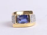 an image of a ring with a blue sapphire and diamonds
