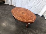 a small table with a wooden top on a cement floor