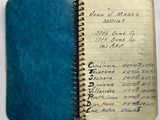 an old book with writing on it sitting on a table