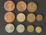 a lot of coins that are on a black surface