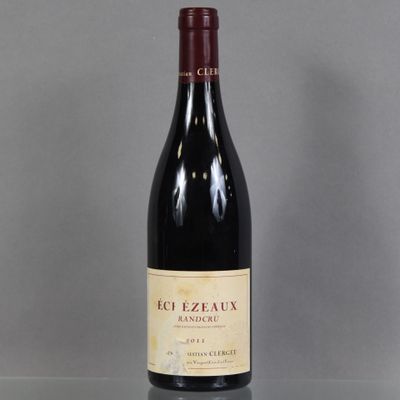 a bottle of red wine sitting on a glass table