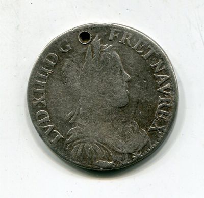une vieille pièce d'argent sur laquelle est représenté le visage d'une femme