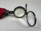 a magnifying glass and a red cloth on a table