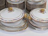 a lot of plates and bowls on the table
