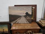 a picture of a painting on a dresser next to a picture of a road