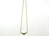 a close up of a necklace on a white surface with a white background