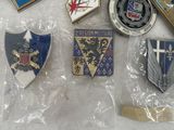 some of the badges are in plastic bags on a table