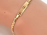 un gros plan sur le bras d'une personne portant un bracelet en or