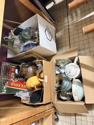 a box full of assorted items sitting on a kitchen counter