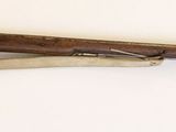 un fusil en bois accroché au mur d'une pièce