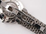 a close up of a watch on a white surface