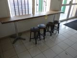 three stools sitting in front of a table in a room