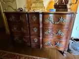 a dresser that has a clock on top of it