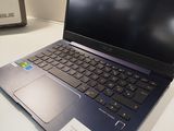 a laptop computer sitting on a table with a box in front of it