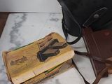 a bag, a book, and some other items on a table