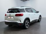 the rear end of a white suv parked in a room