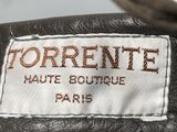the label of a black leather jacket with a white and brown logo