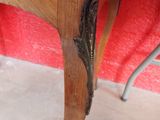 a wooden table with a metal handle on top of it