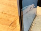 a computer monitor sitting on top of a wooden table