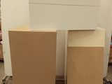 Deux cartons sont empilés sur une palette dans un entrepôt.
