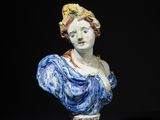 a close up of a statue of a woman on a pedestal
