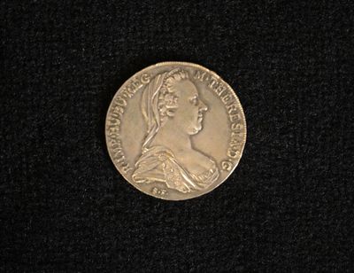 a close up of a coin on a black surface