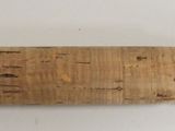 a close up of a wooden object on a white surface