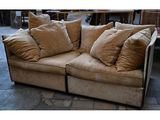 a couch that has many pillows on it in a room