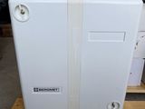 a white refrigerator sitting on a pallet in a warehouse