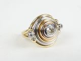 a close up of a gold and silver ring with a diamond