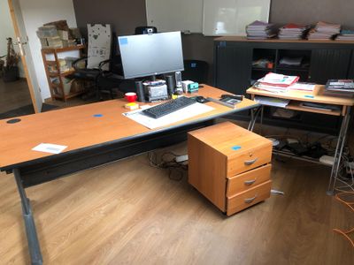 a desk with a computer on it in a room