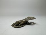 bronze statue of a hand holding a leaf on a white surface