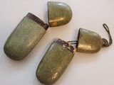 three antique silver plated lighters on a white surface