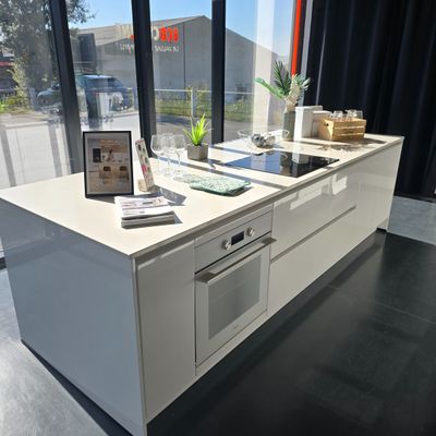 a kitchen with a stove, oven, sink and a window