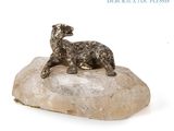 a statue of a dog sitting on top of a rock