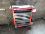 a red tool cart with a lot of drawers on it