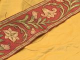 an image of a close up of a red and yellow table runner