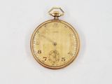 an antique pocket watch on a white surface with a white background