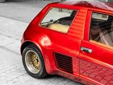 a red car that is parked on the side of the street