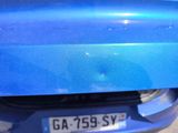 a close up of a blue car with a number plate on it