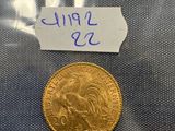 a gold coin with a label on it sitting on top of a blue cloth