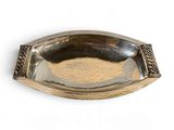 a silver plate with a decorative design on it