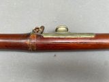 a close up of a wooden pipe with a brass handle