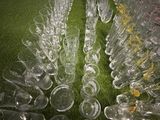 a lot of empty wine glasses sitting on the floor