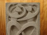 a stone block with a design on it on a table