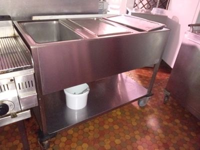 a stainless steel sink and a stove in a kitchen