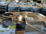 many boxes of food sitting on a table covered in plastic